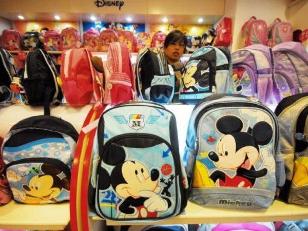 A Chinese vendor sells Mickey Mouse bags and other products at a Disney store in Shanghai on Nov. 4, 2009. (STR/AFP/Getty Images)