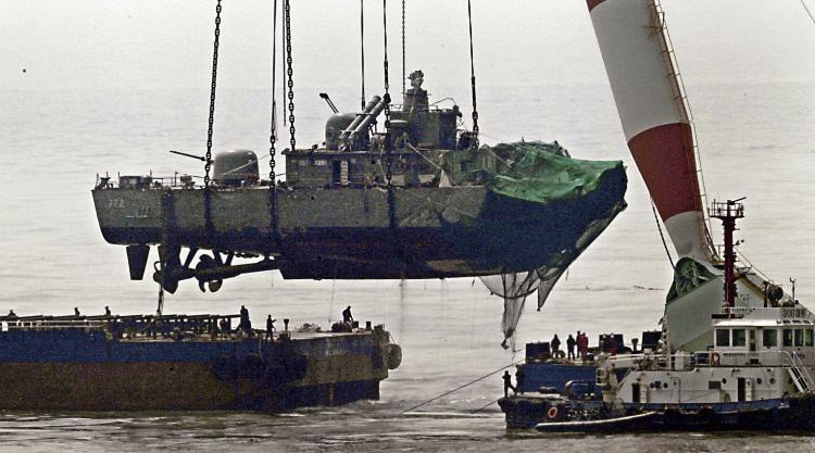 A giant floating crane lifts the stern of a South Korean warship to place it on a barge on April 15, 2010. The 1,200-ton patrol combat corvette PCC-772 Cheonan was split in two by a big external explosion on March 26 near a disputed Yellow Sea border. (Hong Jin-Hwan/AFP/Getty Images)