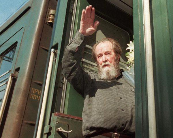 Russian writer Alexander Solzhenitsyn waves as he gets on a train on June 1, 1994, in Vladivostok bound for Khabarovsk. Russian writer and dissident Solzhenitsyn died on Aug. 3, 2008, at the age of 89. (Michael Estafiev/Getty Images)