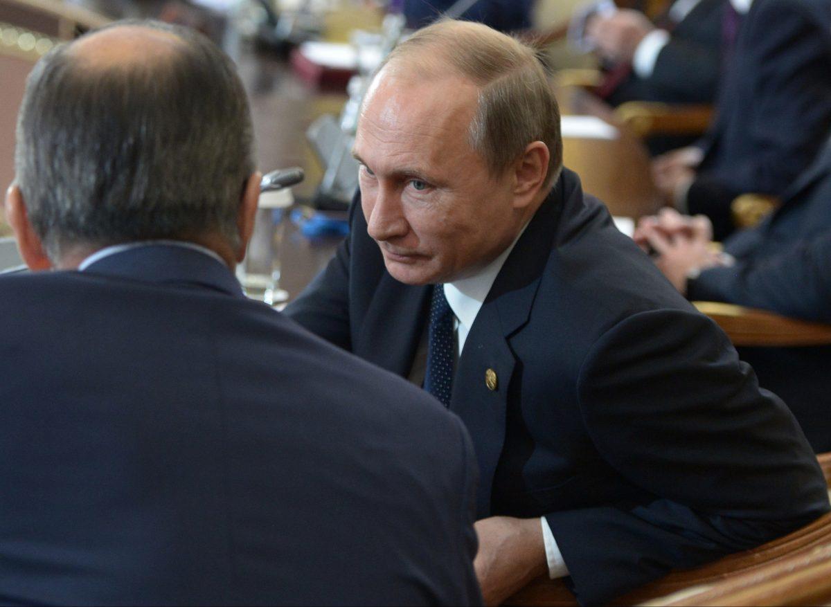 Russian President Vladimir Putin talks with Russian Foreign Minister Sergey Lavrov (back to a camera) during a Commonwealth of Independent States, former Soviet republics, summit in Astana, Kazakhstan, on Oct. 16, 2015. (Alexei Nikolsky/RIA-Novosti/Kremlin Pool Photo via AP)