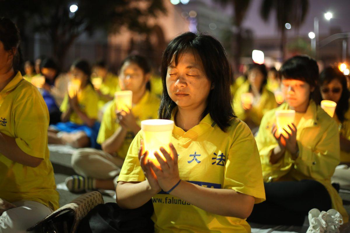 Falun Gong practitioners hold a candlelight vigil in front of the Chinese Consulate in Los Angeles on Oct. 15, 2105, for those who have died during the persecution in China. (Benjamin Chasteen/Epoch Times)
