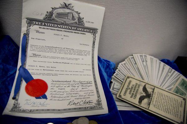 A patent for a mail slot, left, and U.S. war and savings bonds in the Nevada State Treasurer's office in Las Vegas on Apr. 27, 2012, part of numerous unclaimed properties that the state is trying to reunite with their owners. (AP Photo/Julie Jacobson)