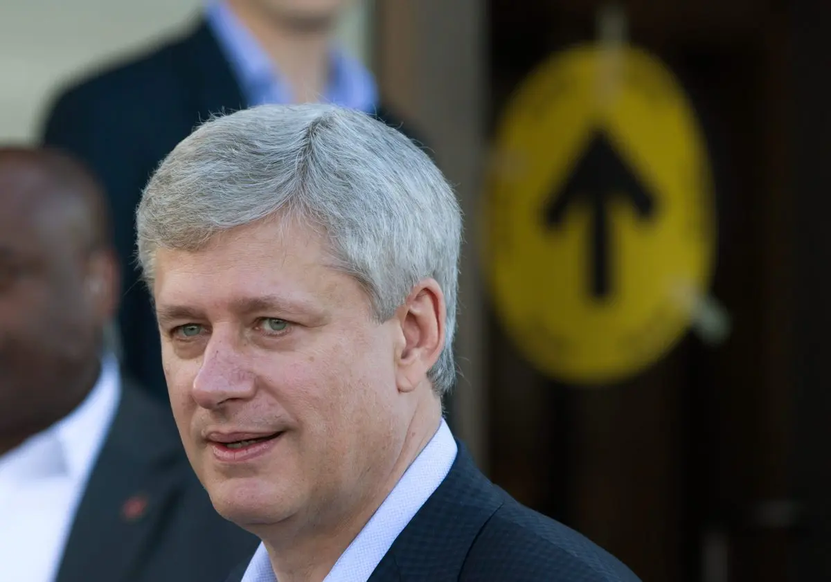 Prime Minister Stephen Harper leaves a polling station after casting his ballot in the federal election in Calgary on Oct. 19, 2015. (Darryl Dyck/The Canadian Press via AP)