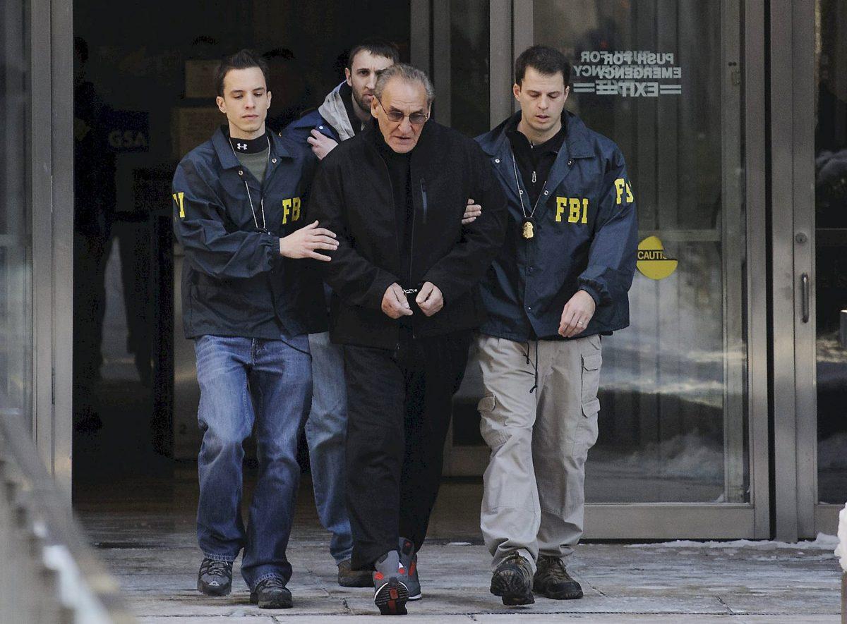 FBI agents flank Vincent Asaro as they escort the reputed mobster from FBI offices in New York City on Jan. 23, 2014. (Charles Eckert/Newsday via AP)