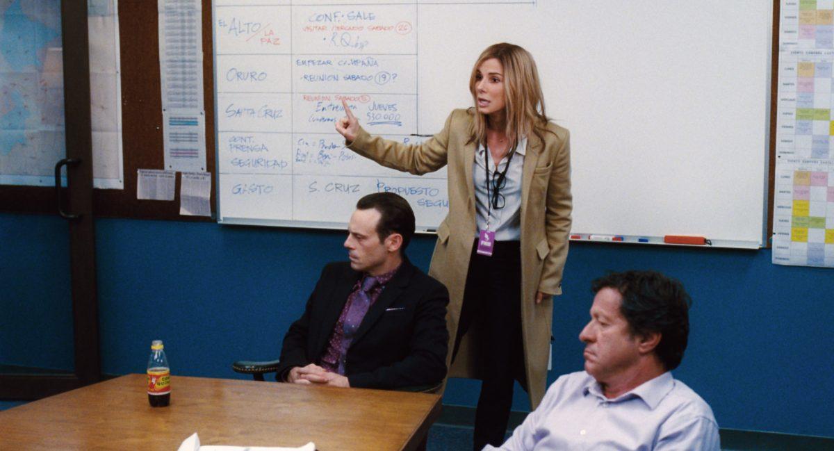 (L–R) Buckley (Scoot McNairy), Jane (Sandra Bullock), and Castillo (Joaquim de Almeida), in "Our Brand Is Crisis." (Warner Bros. Entertainment Inc./RATPAC-DUNE Entertainment LLC)
