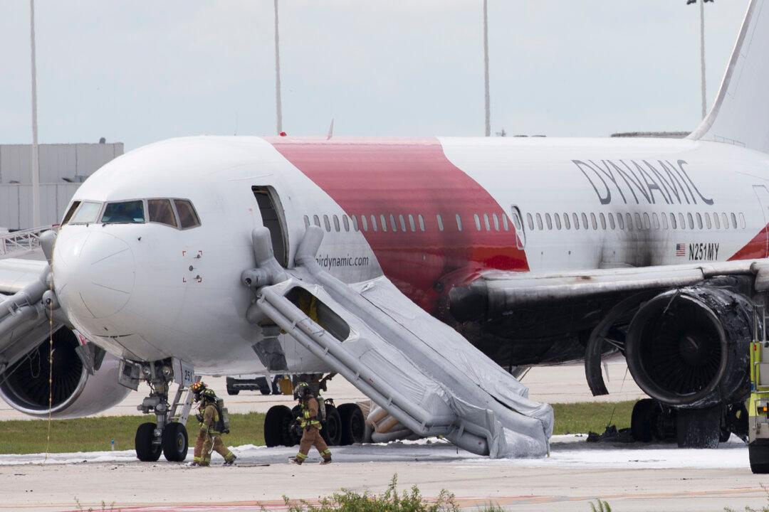 Plane Catches Fire at Airport; Passengers Evacuate on Slides