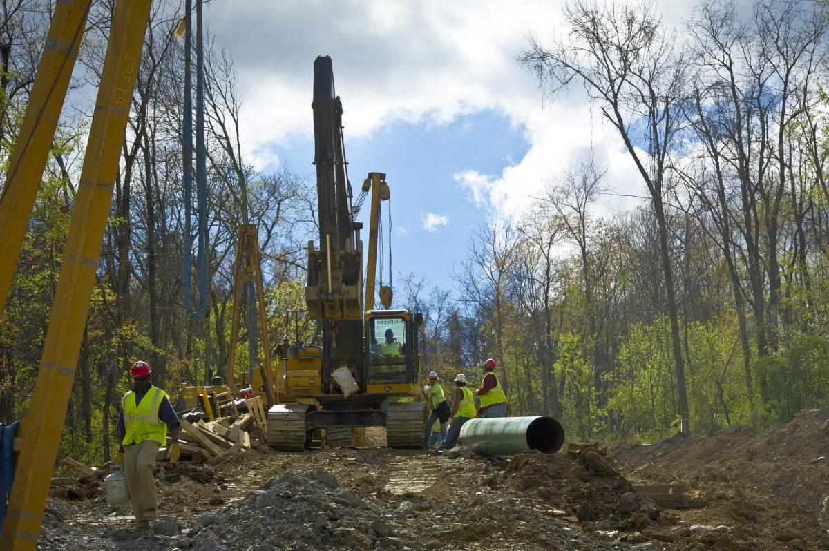 Workers lay the pipes of a gas pipeline outside the town of Waynesburg, Penn., on April 13, 2012. (Mladen Antonov/AFP/Getty Images)