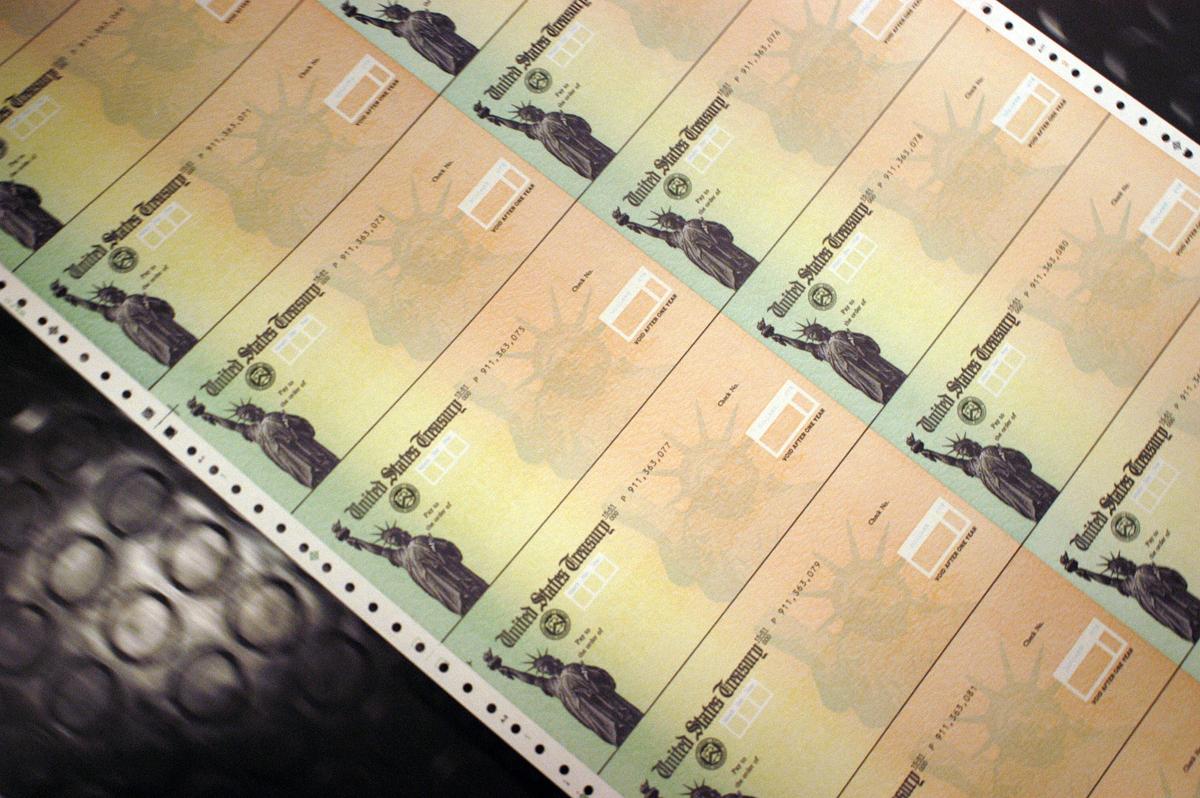 Blank Social Security checks are run through a printer at the U.S. Treasury printing facility in Philadelphia, Pennsylvania, on Feb. 11, 2005. (William Thomas Cain/Getty Images)
