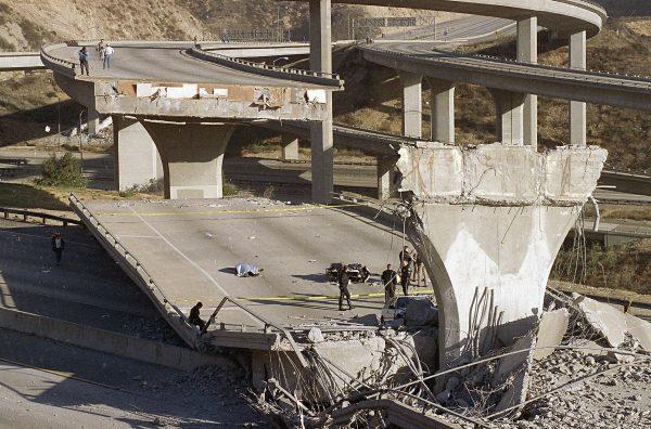The covered body of Los Angeles Police Officer Clarence Wayne Dean, lies near his motorcycle which plunged off the State Highway 14 overpass that collapsed onto Interstate 5, after a magnitude-6.7 Northridge earthquake hit on Jan. 17, 1994. (Doug Pizac/AP Photo)