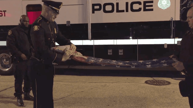 Milwaukee Officers Ceremoniously Fold Flag Burned by Protester Outside GOP Debate