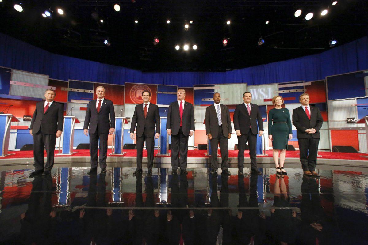 Republican presidential candidates (L-R) John Kasich (L), Jeb Bush (2L), Marco Rubio (3L), Donald Trump (4L), Ben Carson(4R), Ted Cruz (3R), Carly Fiorina (2R), and Rand Paul (R) take the stage before the Republican presidential debate at the Milwaukee Theatre, on Nov. 10, 2015, in Milwaukee. (Jeffrey Phelps/AP Photo)