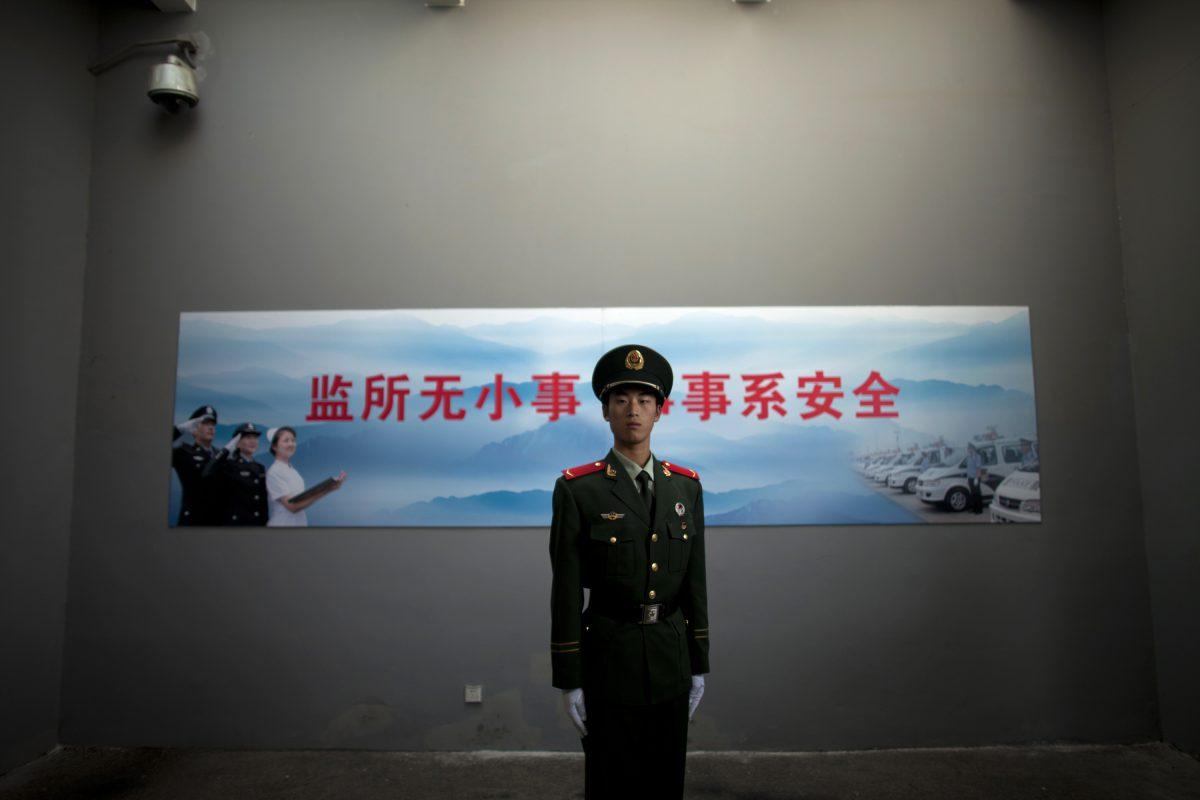 A Chinese paramilitary policeman stands guard at an entrance to the Number Two Detention Center in Beijing, China, on Oct. 25, 2012. A report by Amnesty International on Nov. 12, 2015 details the Chinese regime's practice of using torture to extract confessions from detainees. (Alexander F. Yuan/AP Photo)