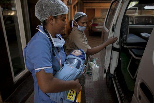 A newborn baby is transferred to an ambulance at the Akanksha Clinic, one of the most organized clinics in the surrogacy business, in Anand, India on Nov. 3, 2015. (AP Photo/Allison Joyce)