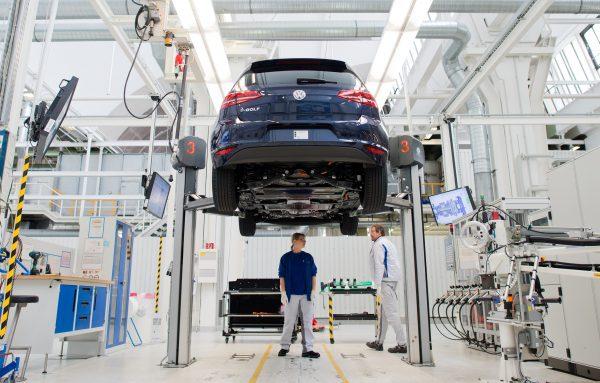 Employees of German carmaker Volkswagen (VW) work on an electric car e-Golf on an assembly line at VW plant in Wolfsburg, central Germany, on Oct. 21, 2015. (Julian Stratenschulte/AFP/Getty Images)
