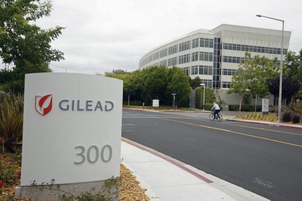 A man cycles near the headquarters of Gilead Sciences in Foster City, Calif., on July 9, 2015. (AP Photo/Eric Risberg)