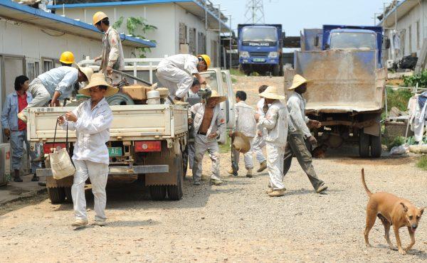 Workers from China and Burkina Faso employed by Sinohydro, a Chinese-owned hydropower engineering and construction company, return after a working day in Bata, Equatorial Guinea, on Jan. 31, 2012. (ABDELHAK SENNA/AFP/Getty Images)