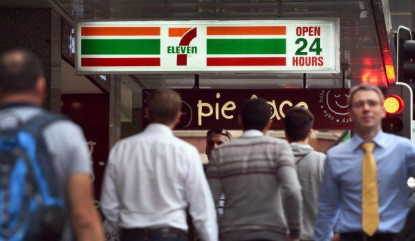 People walk past a 7-Eleven convenience store in Sydney's central business district in Australia on Sept. 30, 2015. (William West/AFP/Getty Images)