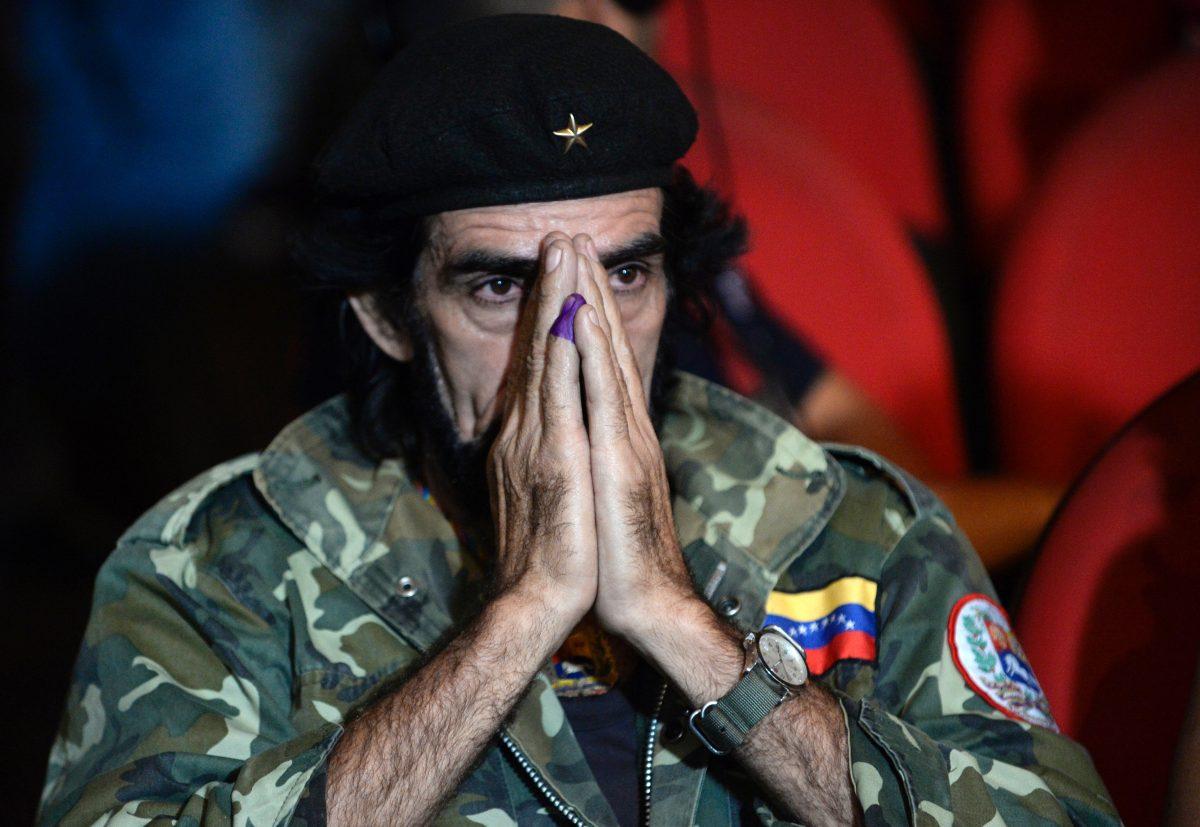 A supporter of Venezuelan President Nicolas Maduro, portraying guerrilla leader Ernesto Che Guevara, waits for the results of the legislative election, in Caracas, on Dec. 7, 2015. (Federico Parra/AFP/Getty Images)