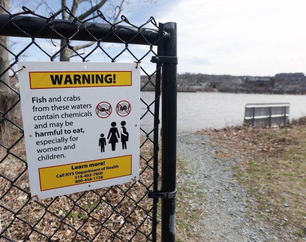 A warning sign hangs on a gate at River Park in Green Island, N.Y., on Tuesday, April 14, 2015. (AP Photo/Mike Groll)