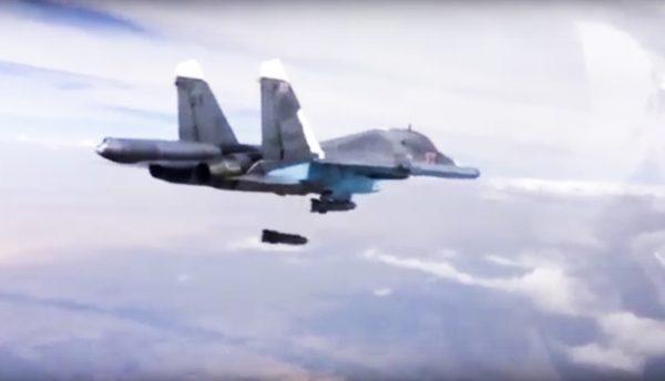 A new report by a human rights watchdog group accuses Russia of using cluster munitions and unguided bombs on civilian areas in Syria from Su-34 bombers like the one above dropping bombs on a target in Syria on Dec. 9. (Russian Defense Ministry Press Service via AP)