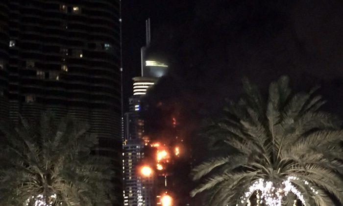 Dubai New Year Fireworks Kick Off While Nearby Tower Blazes