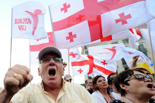 Protesters wave Georgia's national flag, also known as the Five Cross Flag, as they take part in a rally against Russia in Tbilisi, Georgia, on July 18, 2015. (Vano Shlamov/AFP/Getty Images)