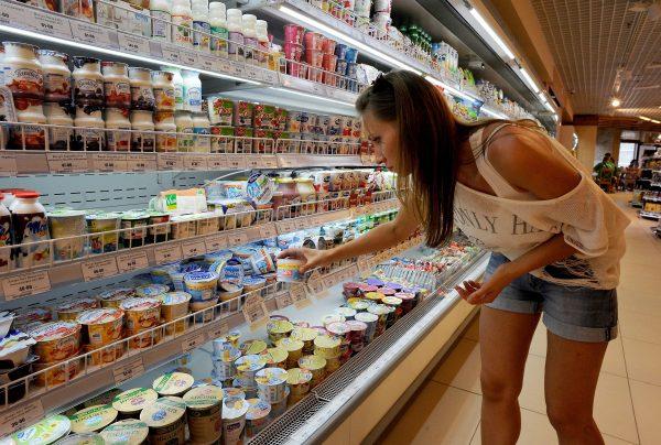 A woman shops for yogurt, a food commonly associated with good gut bacteria known as probiotics. (Olga Maltseva/AFP/Getty Images)