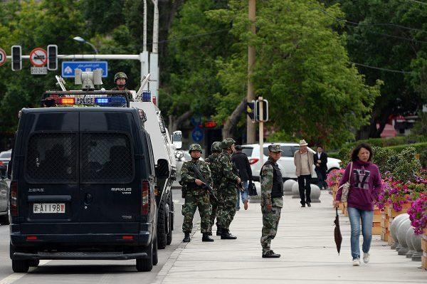 Chinese paramilitary police officers stand guard along a street in Urumqi, Xinjiang, on May 23, 2014. (Goh Chai Hin/AFP/Getty Images)