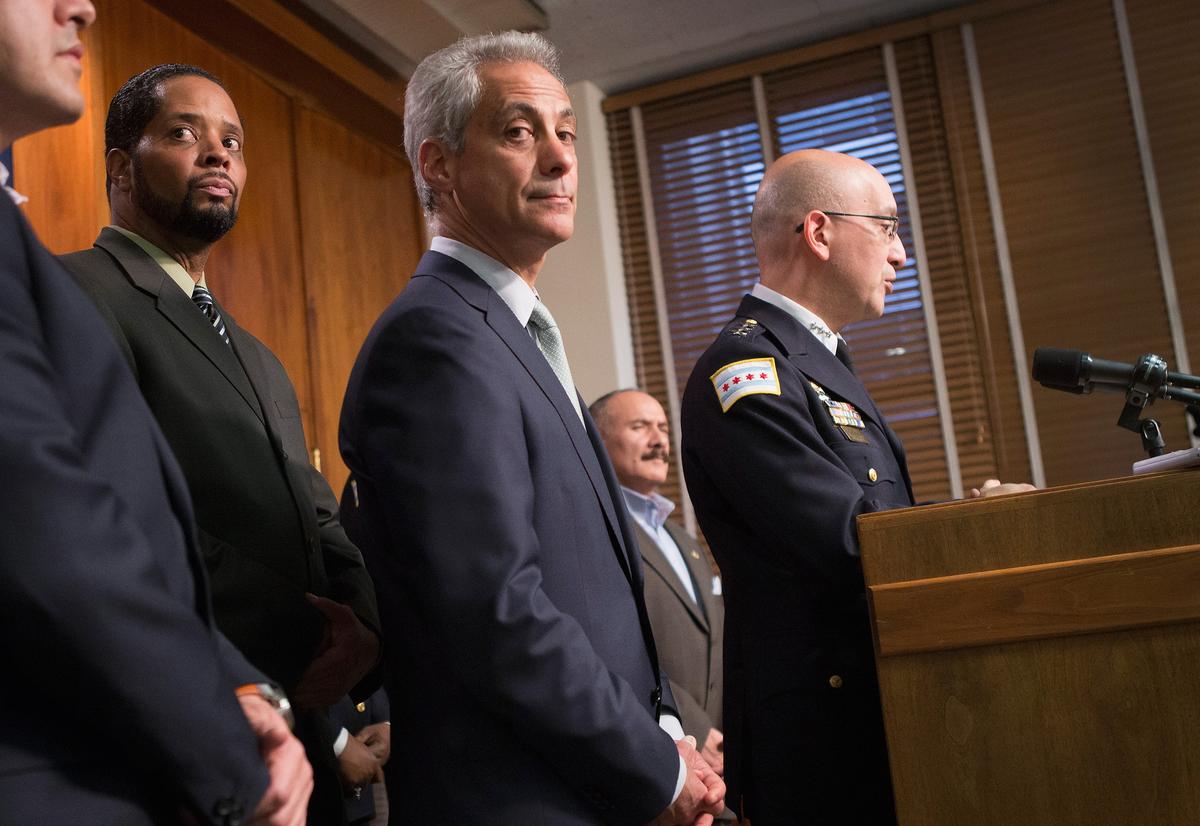 Chicago Mayor Rahm Emanuel (C) listens as Interim Police Superintendent John Escalante addresses changes in training and procedures at the city's police department, sparked by a rash of shootings, on Dec. 30, 2015. (Scott Olson/Getty Images)