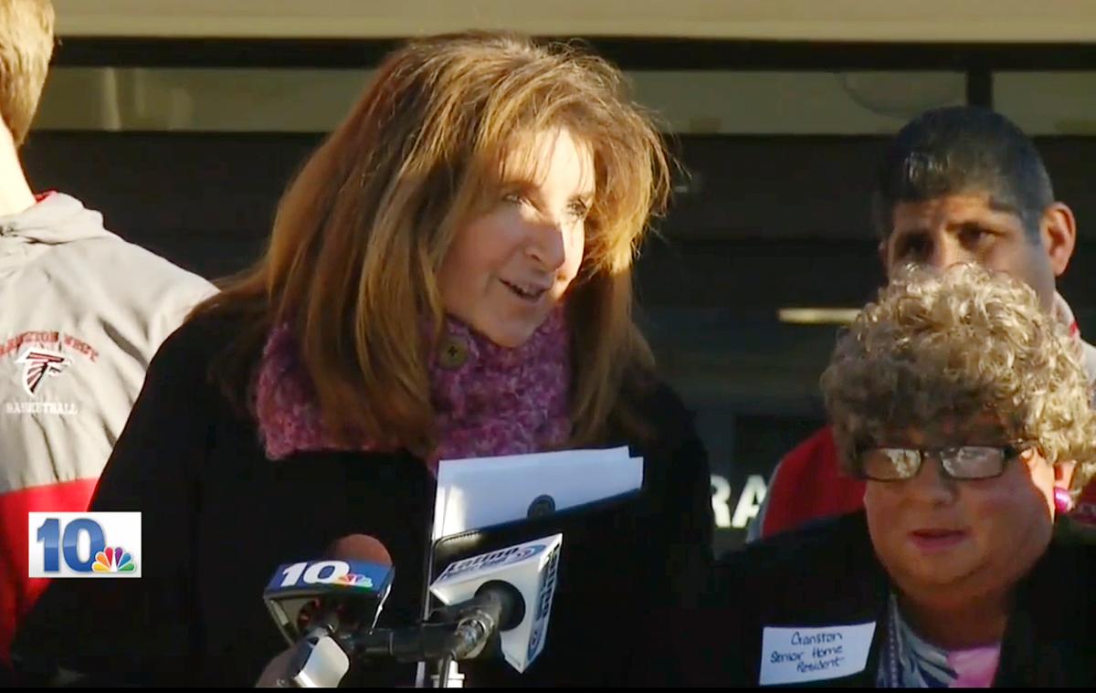 Middle-Aged Man Dresses as Old Woman for Official’s Photo Op