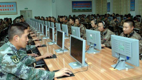 Chinese soldiers work at computers. The Chinese regime’s cyberattacks against the United States have continued despite cyber agreements. (mil.huanqiu.com)