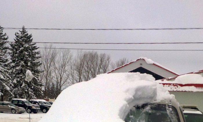 Man Charged After His Car Almost Completely Covered in Snow