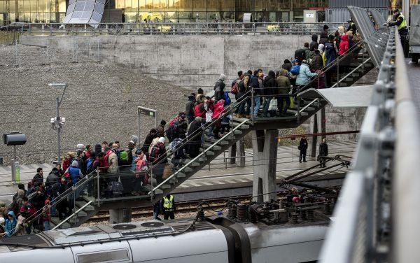 Police organize a line of refugees on the stairway leading up from the trains arriving from Denmark at the Hyllie train station outside Malmo, Sweden, on Nov. 19, 2015. (Johan Nilsson/AFP/Getty Images)
