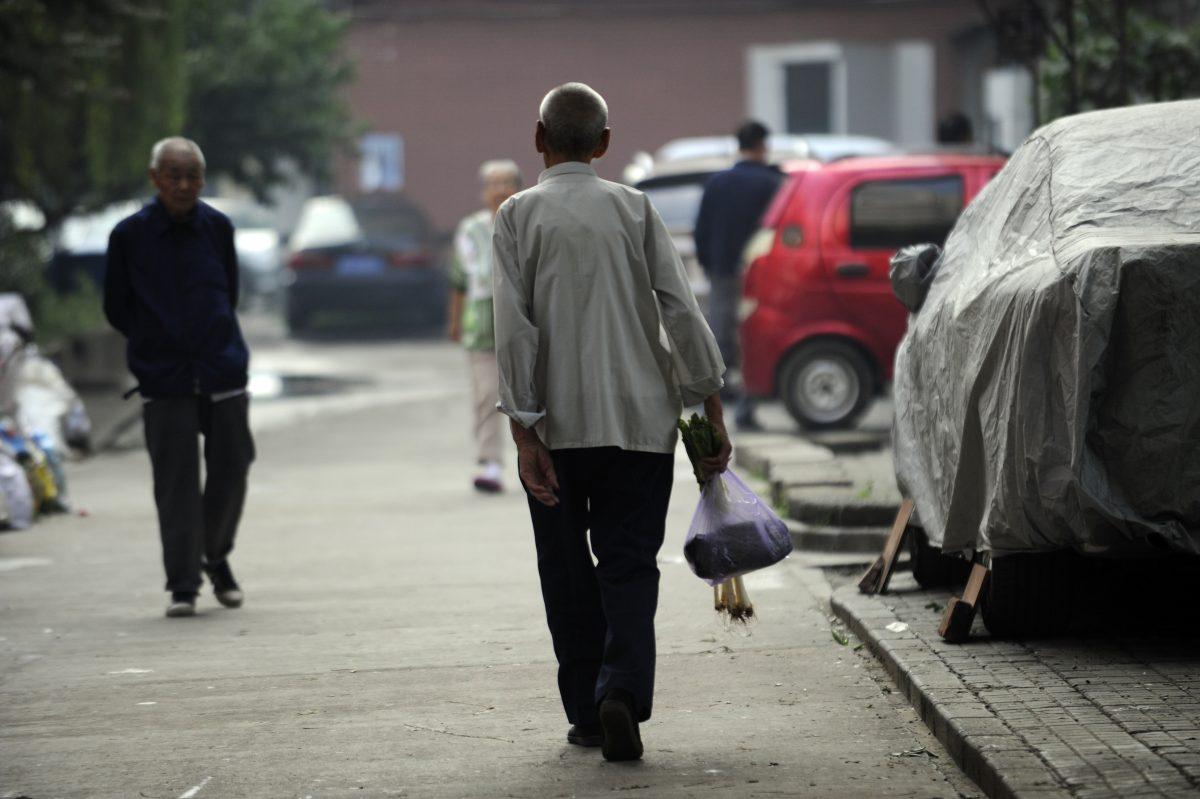 An elderly man making his way home after buying some vegetables from a market in Beijing on Sept. 7, 2012. (Wang Zhao/AFP/Getty Images)