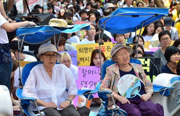 Kim Bok-dong (L) and Gil Won-ok, who were forced to serve as sex slaves for Japanese troops during the Second World War, attend a protest with other supporters outside the Japanese embassy in Seoul, South Korea, on Aug. 12, 2015. (Jung Yeon-je/AFP/Getty Images)