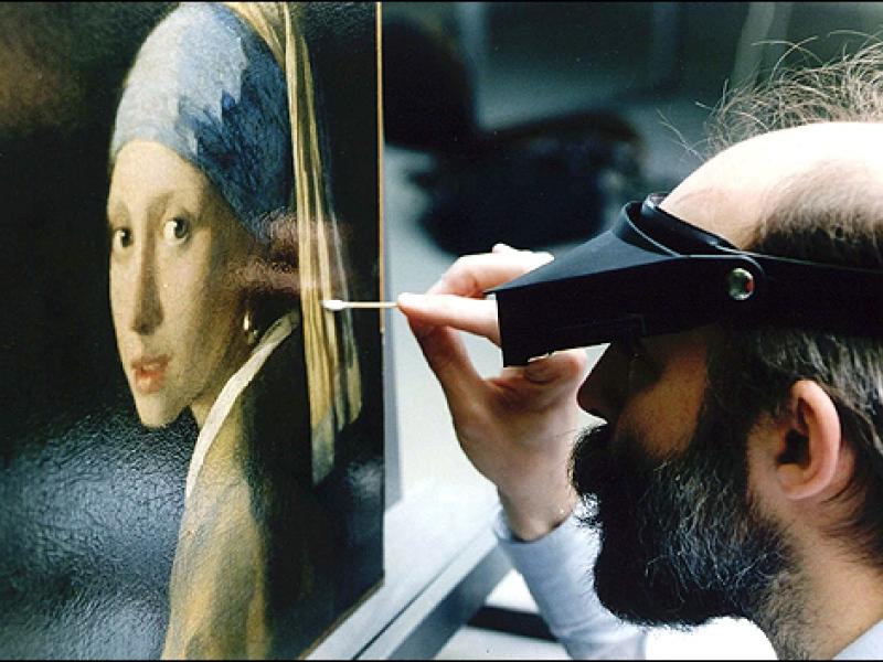 Jørgen Wadum cleans the "Girl with a Pearl Earring," when he was the Chief Conservator at the Mauritshuis in The Hague in 1994. (Courtesy of Jørgen Wadum)