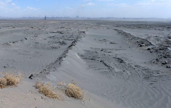 An about four-square-mile expanse of radioactive waste outside Baotou City in northern China on April 21, 2011. Strong winds whip up the cancer-causing materials dumped by producers of rare-earth minerals, iron ore, and steel, poisoning surrounding villages and farms. China's Ministry of Environmental Protection acknowledged that there are at least 450 pollution-related “cancer villages” in the country. (Frederic J. Brown/AFP/Getty Images)
