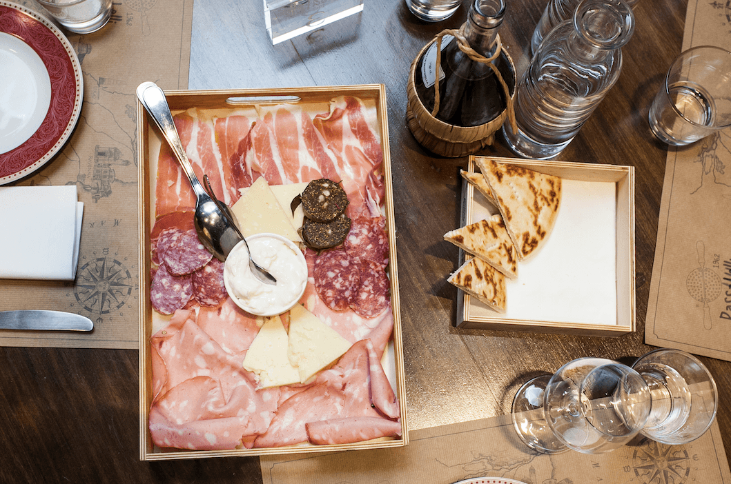 Cured meats, cheeses, and piadina bread at Osteria Passatelli in Ravenna, Italy. (Channaly Philipp/The Epoch Times)