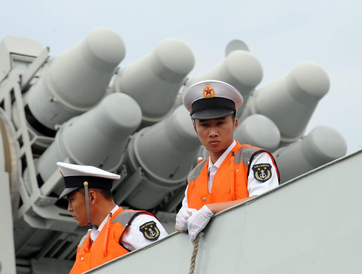 Sailors with the Chinese navy stand on the deck of a missile frigate in Manila on April 13, 2010. (Ted Aljibe/AFP/Getty Images)