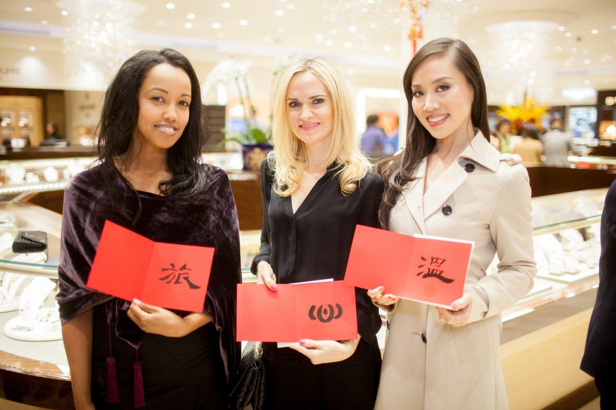 Customers display Chinese calligraphy during the unveiling of Qeelin Collections and Chinese New Year Festivities at CH Premier Jewelers in the Westfield Shopping Center in Santa Clara, Calif., on Feb. 20. (Christian Lambert for Epoch Times)