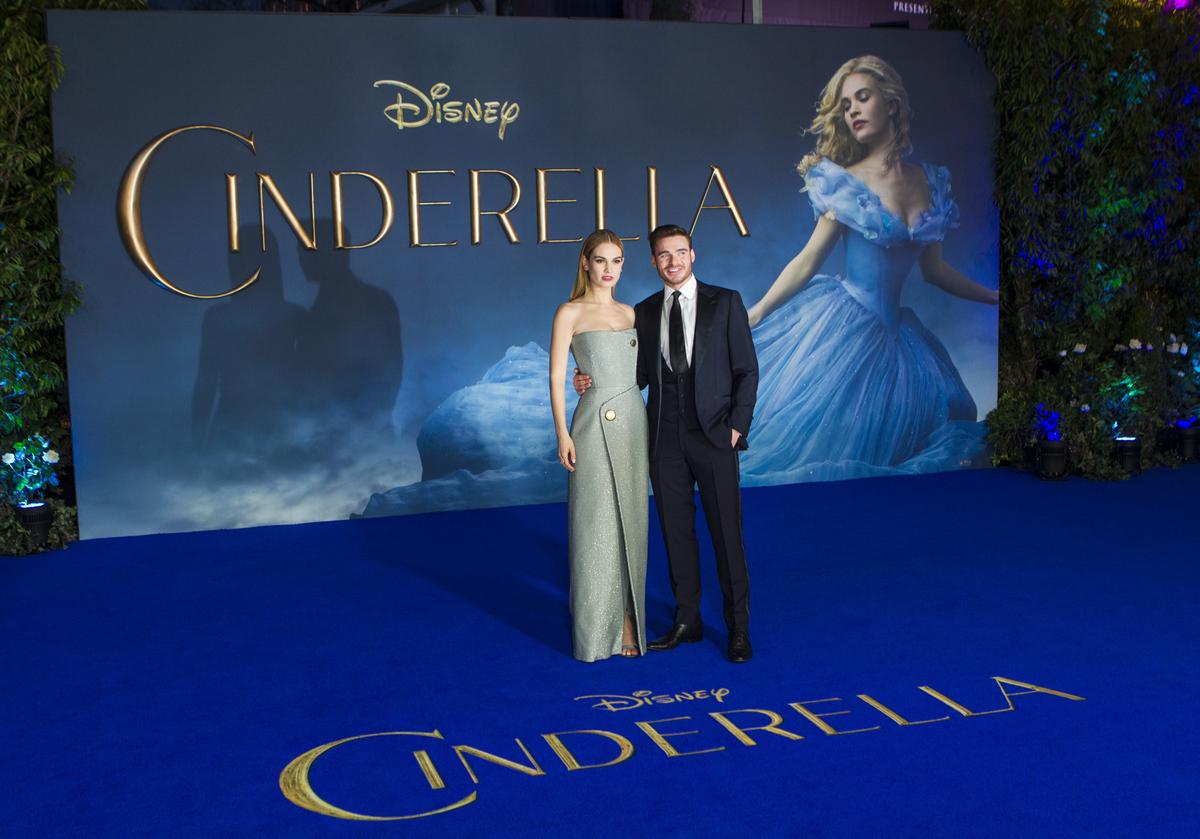 British actors Lily James (L) and Richard Madden pose for photographers on the red carpet ahead of the UK premiere of the film 'Cinderella' in central London on March 19, 2015. (Jack Taylor/AFP/Getty Images)
