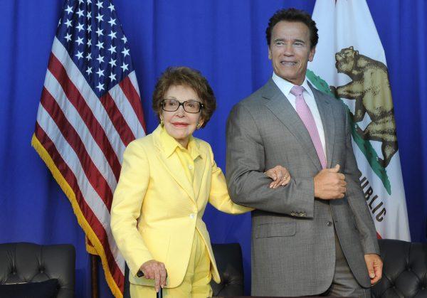 Nancy Reagan is escorted by then-California Gov. Arnold Schwarzenegger after the ceremonial signing of California Senate Bill 944 and Assembly Bill 1911 honoring President Reagan at the Ronald Reagan Presidential Library in Simi Valley, Calif., on July 28, 2010. (AP Photo/Adam Lau)