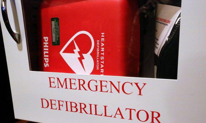  An emergency defibrillator, used to treat life-threatening conditions that affect the rhythm of the heart such as cardiac arrhythmia, hangs on the wall at the Illinois State Capitol on July 1, 2014, in Springfield, Ill. (AP Photo/Seth Perlman)
