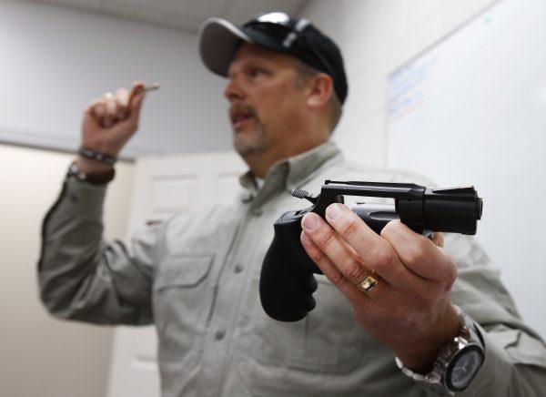 Gun instructor Mike Stilwell, demonstrates a revolver as he teaches a packed class to obtain the Utah concealed gun carry permit, at Range Master of Utah, on Jan. 9, 2016, in Springville, Utah. (George Frey/Getty Images)