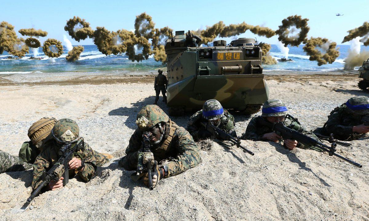 U.S. and South Korean Marines take positions after landing on the beach during the joint military combined amphibious exercise in Pohang, South Korea, on March 12, 2016. (Kim Jun-bum/Yonhap via AP)