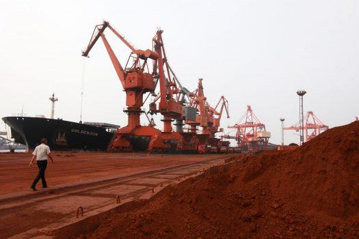 Bulldozer scoop soil containing various rare-earth to be loaded on to a ship at a port in Lianyungang, east China's Jiangsu Province on Sept. 5, 2010, for export to Japan. (STR/AFP/Getty Images)
