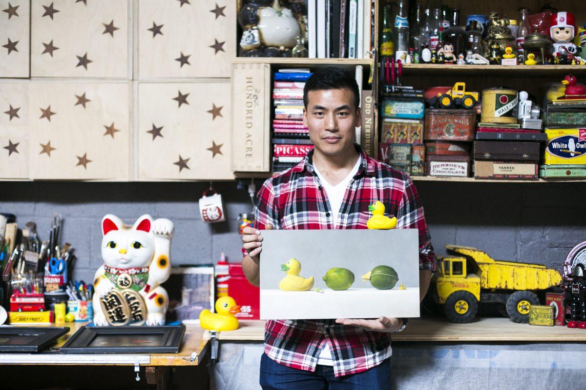 Artist Samuel Hung holds one of his paintings at his studio space in Grand Central Atelier in Long Island City, New York, on March 16, 2016. (Samira Bouaou/Epoch Times)