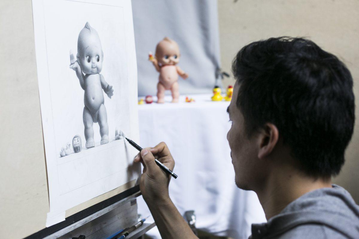 Artist Samuel Hung touches up his drawing of Kewpie in Grand Central Atelier, on March 7, 2016. (Samira Bouaou/Epoch Times)