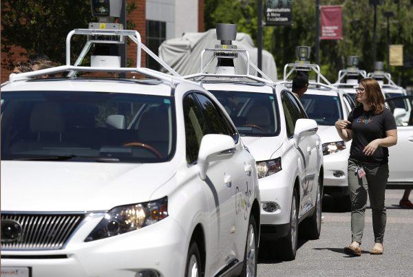 A row of Google self-driving Lexus cars are parked at a Google event in Mountain View, Calif., on May 13, 2014. (Eric Risberg/AP Photo)