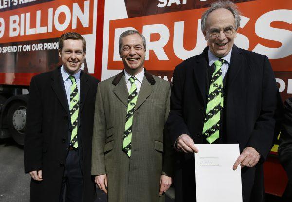 Conservative members of Parliament, Tom Pursglove (L) and Peter Bone (R), stand with Nigel Farage, as they hold the application letter outside the Electoral Commission in London on March 31, 2016. (AP Photo/Kirsty Wigglesworth)